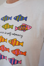 White t-shirt with colorful fish illustrations and text on a plain background