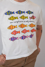 White t-shirt with colorful fish illustrations and text on a plain background