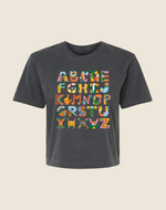 A gray t-shirt with the alphabet in colorful letters, each representing different assistive tools and technologies related to disability and access.