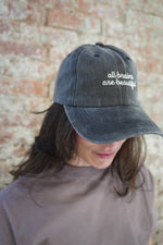 Person wearing a cap with text on a textured surface