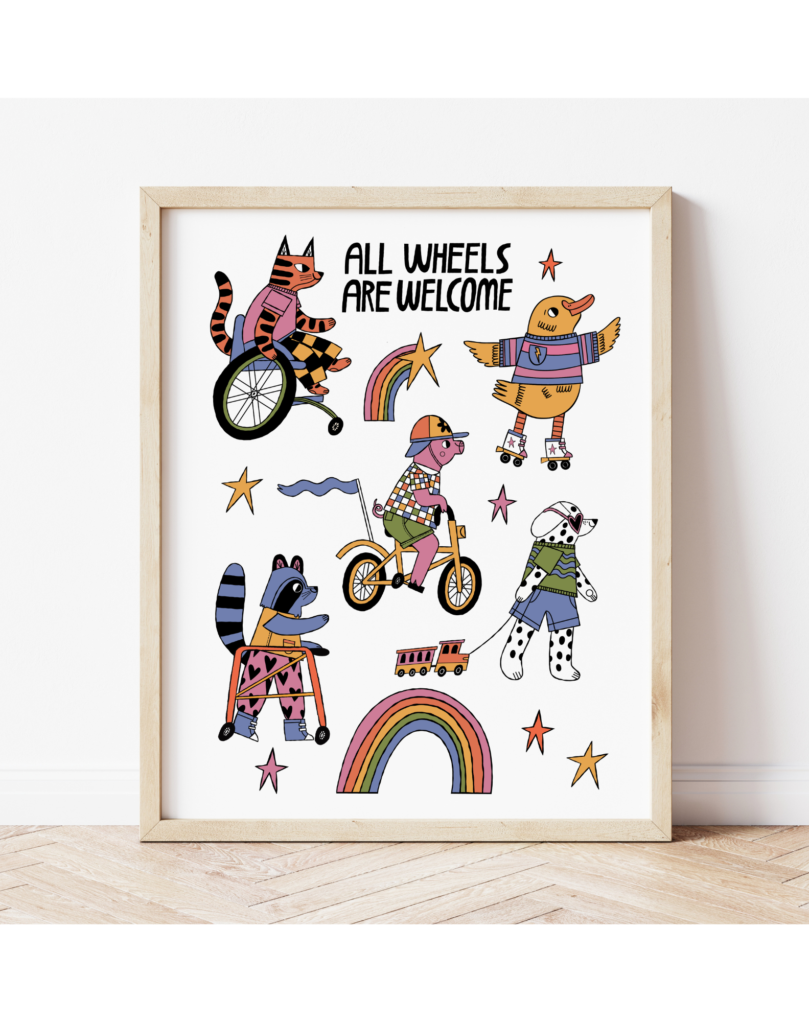 Framed artwork with colorful illustrations of animals on wheels and text 'All Wheels Are Welcome' on a white background.
