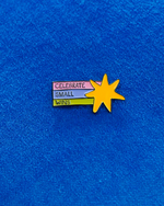 Pin with a yellow star and motivational text on a blue fabric background