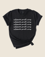 Play Spark Celebrate Small Wins Tee in black featuring a stylish design with the phrase "celebrate small wins" printed repeatedly in white cursive font across the front.