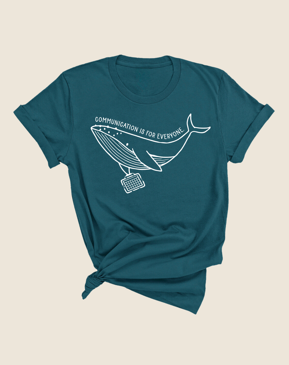 A teal t-shirt with a graphic of a whale and the text 'Communication is for Everyone' on it.