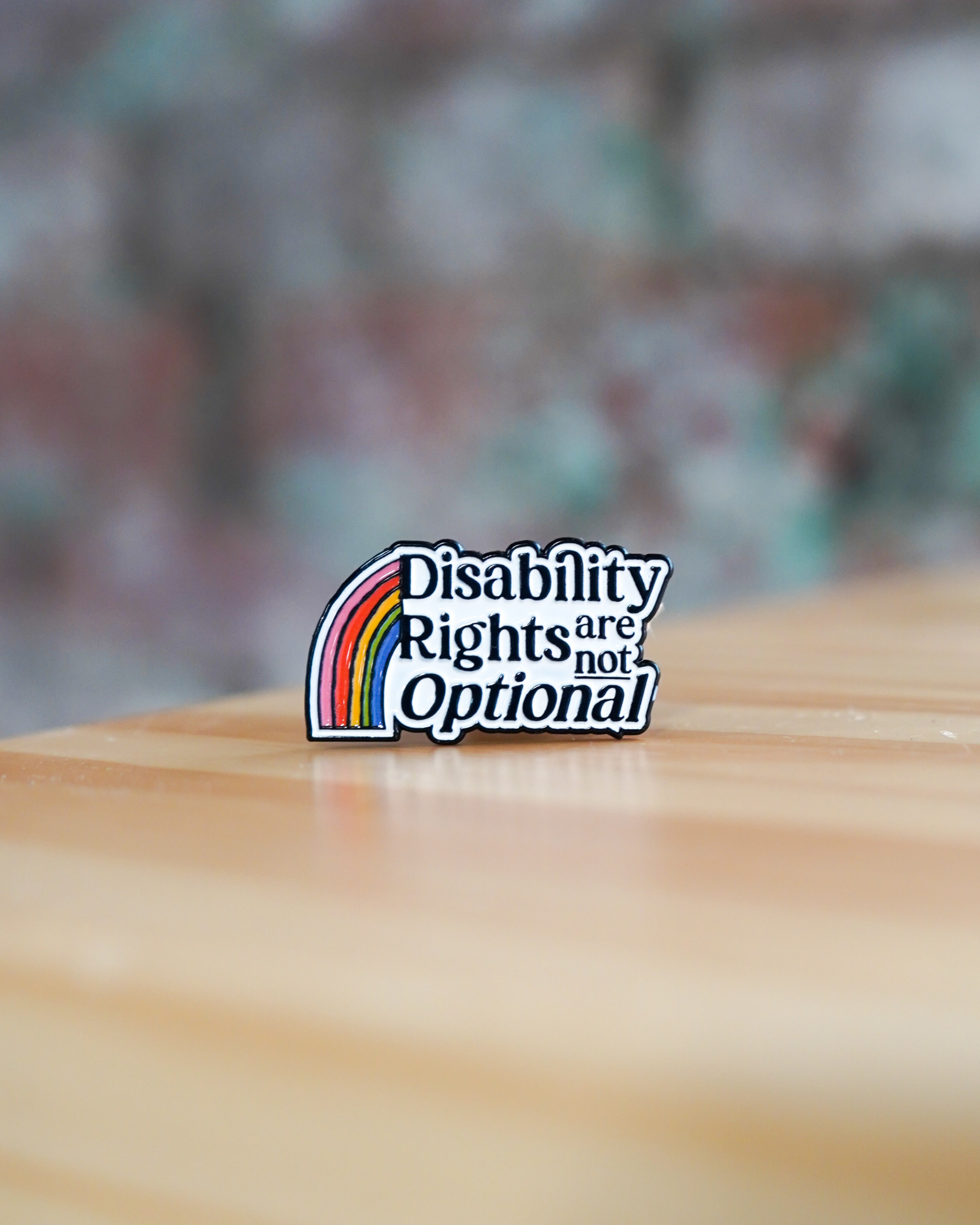 Pin with 'Disability Rights are not Optional' text on a blurred background
