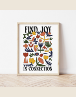 Framed artwork with colorful floral design and text 'Find Joy In Connection' on a white wall.