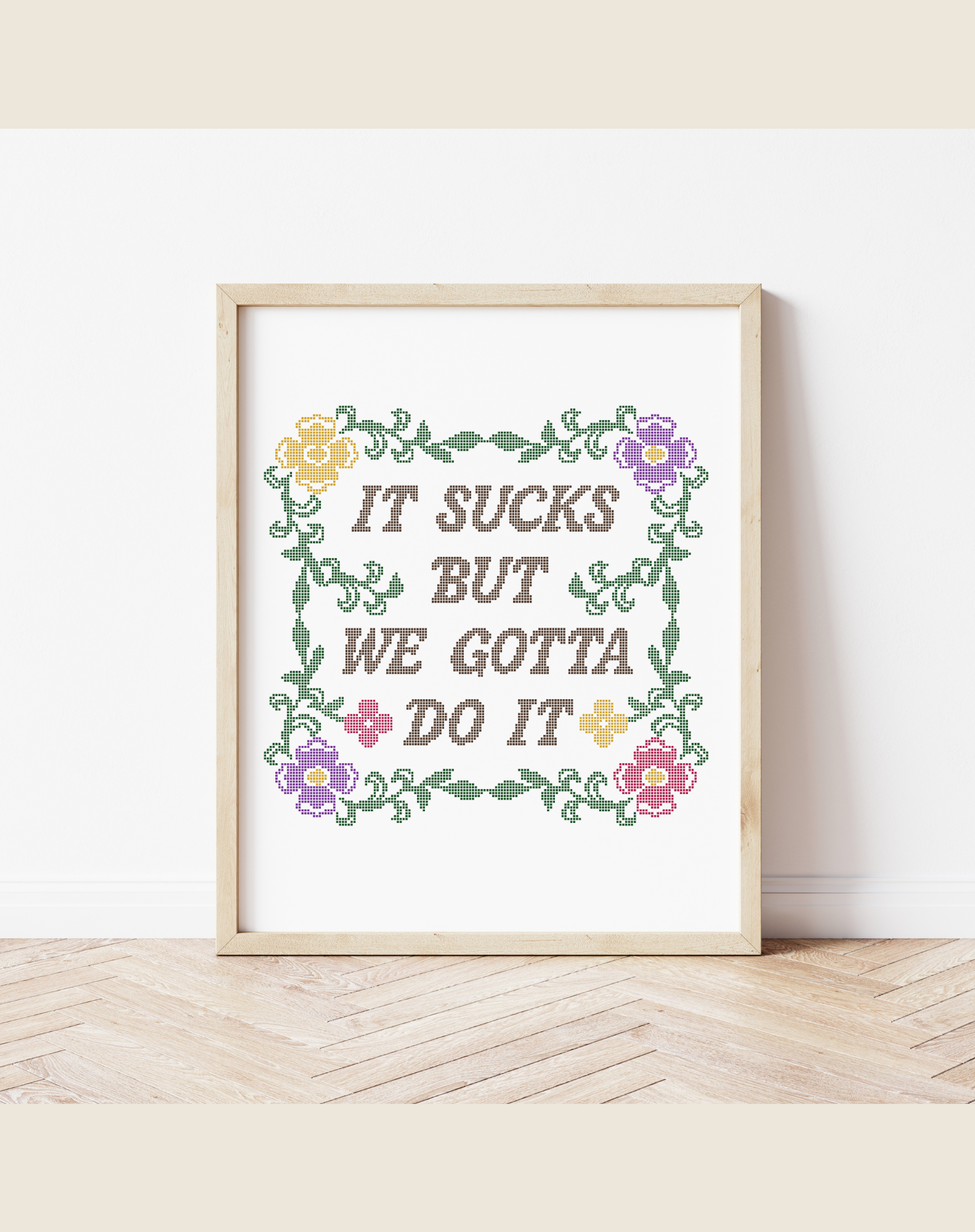 Framed print with motivational quote and floral design on a white wall.