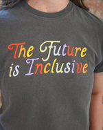 Person wearing a dark gray t-shirt with 'The Future is Inclusive' in colorful letters.