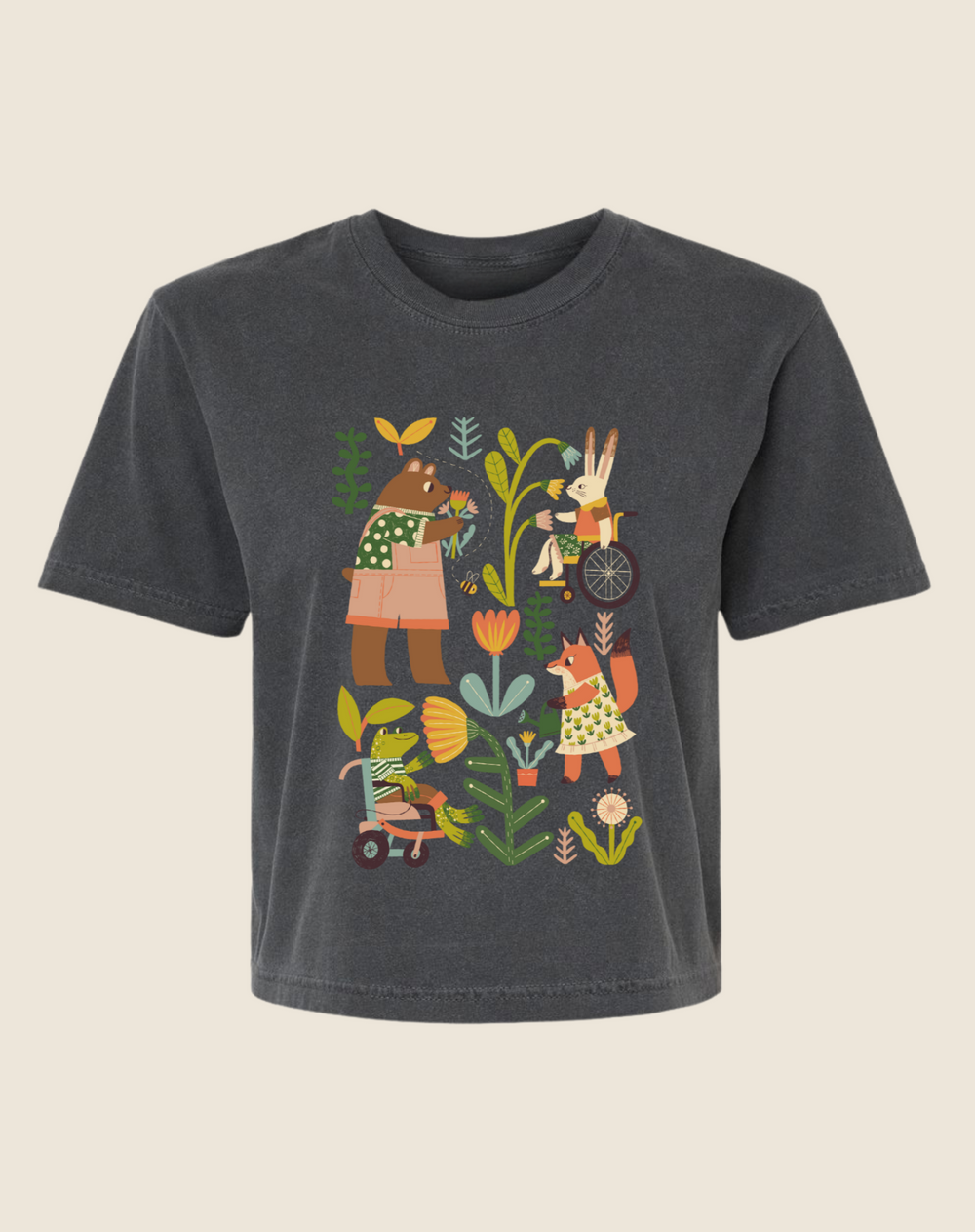 A gray children's t-shirt with an illustration of various characters engaging in gardening activities, including planting and watering plants.