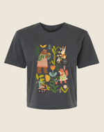 A gray children's t-shirt with an illustration of various characters engaging in gardening activities, including planting and watering plants.